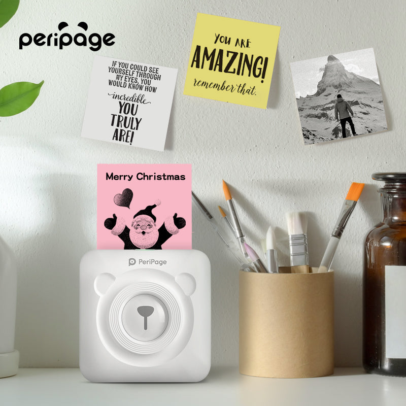 PeriPage A6 mini thermal printer printing Christmas note and motivational quotes, ideal for creative home photo and note printing
