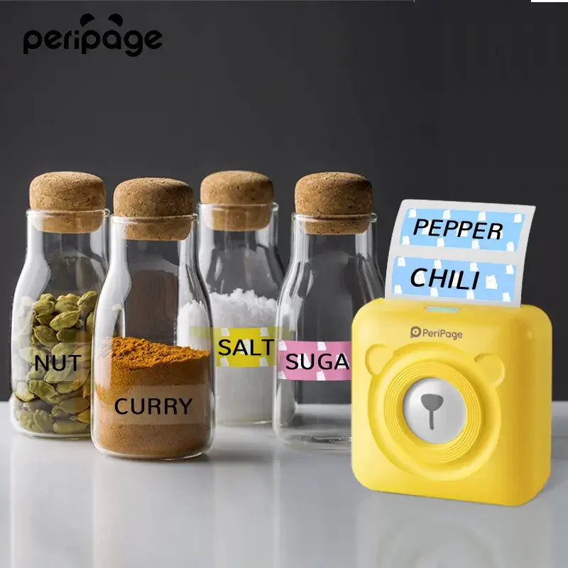 PeriPage 2" A6 Mini Printer used for labeling spice jars with colorful labels such as "PEPPER," "CHILI," and "SUGAR" printed using inkless technology